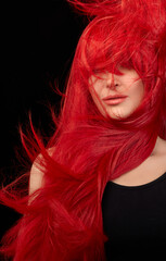 Dyed hair care and fashion concept. Fashion model girl with windswept long dyed red hair