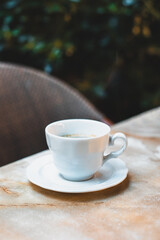 Cup of coffee on a table in a street cafe.