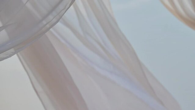 White pergola curtains at seaside, slow motion