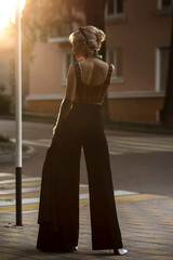 Stylish girl is walking across the road. car sign