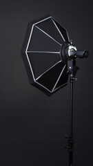 Professional photo studio soft box and flash on the tripod for stillphoto or video production which...