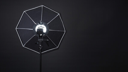 Professional photo studio soft box and flash on the tripod for stillphoto or video production which...
