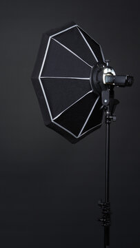 Professional photo studio soft box and flash on the tripod for stillphoto or video production which ready for shape the light for softer, harder or sharper by crew team before shooting on black backgr