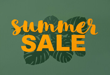 Summer Sale. Light Orange Paper Cut Letters on a Dark Green Background with Monstera Leaves. Simple Discount Composition in a Tropical Style ideal for Banner, Newsletters, Print.