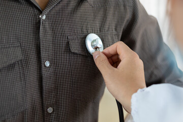 Health care concept medical and diagnosis. Close up doctor using stethoscope physical examination of the patient listening to the respiratory system and lungs.