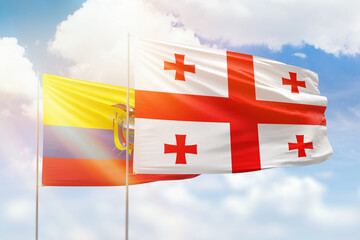 Sunny blue sky and flags of georgia and ecuador