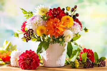 Autumn still life with garden flowers. Beautiful autumnal bouquet in vase on wooden table. Colorful...
