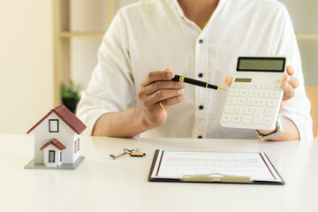 Fototapeta premium Real estate brokers, home sales agents, work on home equity loan documentation to clients and completed home title contracts. at the desk in the office
