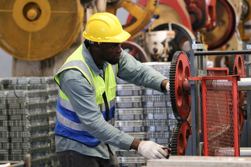 A portrait of technician working or operating in metal factory while maintenance service