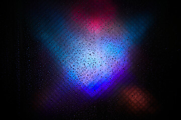 Water drop background. Image refraction of light. Defocused color iridescent radiance texture on a...