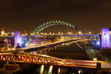 Fototapeta na wymiar Newcastle upon Tyne/England - February 10th 2012: Tyne Bridge and swing bridge at night
