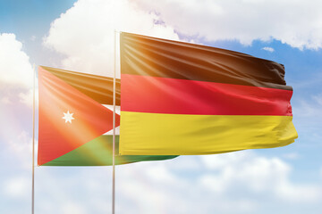 Sunny blue sky and flags of germany and jordan