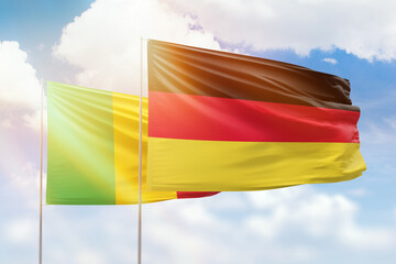 Sunny blue sky and flags of germany and mali
