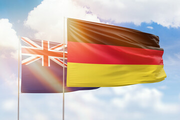 Sunny blue sky and flags of germany and new zealand