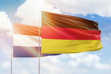 Sunny blue sky and flags of germany and netherlands
