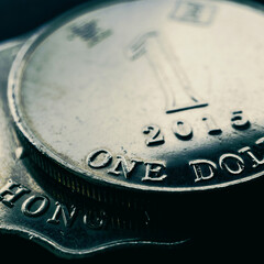 1 one Hong Kong dollar. Fragment of textured coin. Dark tinted square illustration on the theme of economics or banking. Coins and money of Hong Kong. News about the exchange rate or inflation. Macro