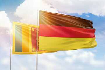 Sunny blue sky and flags of germany and sri lanka
