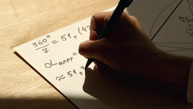 Hand of a young mathematician writing numbers on white paper with using a marker pen. Date of shooting day 10 May 2022 year, MSK time. This video was filmed in Russia.