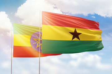 Sunny blue sky and flags of ghana and ethiopia