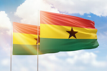 Sunny blue sky and flags of ghana and ghana