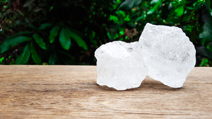 White clear alum cubes on brown woodplank concept for beauty and medical industrial.