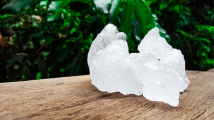 White clear alum cubes on brown woodplank concept for beauty and medical industrial.