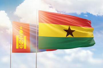 Sunny blue sky and flags of ghana and mongolia
