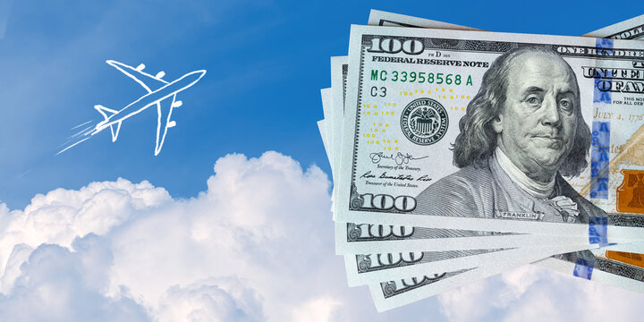 Naive children drawing of airplane above clouds next to US hundred dollar bills. Expensive fuel for flights or saving money for vacation concept