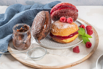Bolas de Berlim, or Berlin Balls. Portuguese fried dough with sugar, Filled with chocolate or raspberry jam. Portuguese fried dough with sugar.