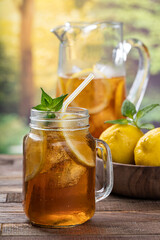 Glass of ice tea with lemon and mint