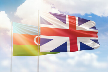 Sunny blue sky and flags of great britain and azerbaijan