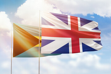 Sunny blue sky and flags of great britain and bahamas