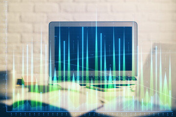 Forex market chart hologram and personal computer background. Multi exposure. Concept of investment.