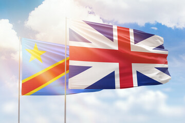 Sunny blue sky and flags of great britain and dr congo