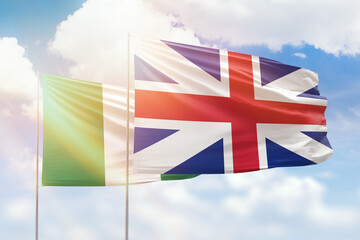 Sunny blue sky and flags of great britain and nigeria