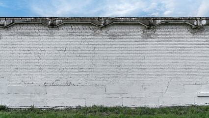 Huge white colored brick wall with empty space for mock up. Large blank brickwork with copy space outdoor. - Powered by Adobe