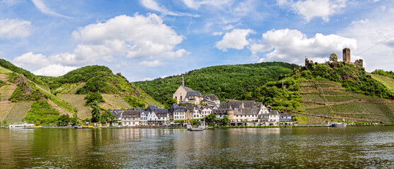 The beautiful village Beilstein in the Moselle valley on a sunny summer day. On a hill above the village are the ruins of Castle Metternich.