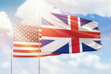 Sunny blue sky and flags of great britain and usa