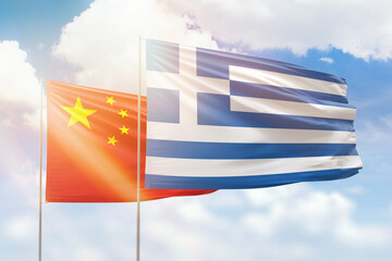 Sunny blue sky and flags of greece and china