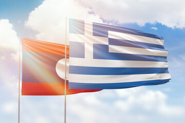Sunny blue sky and flags of greece and laos