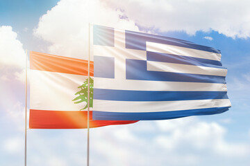 Sunny blue sky and flags of greece and lebanon