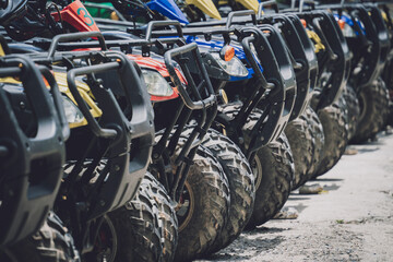 View of row dirty ATVs quad bike