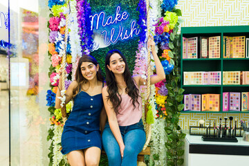 Make a wish. Young women on a swing at the makeup shop