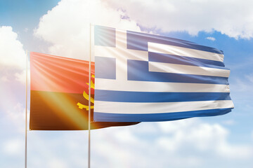 Sunny blue sky and flags of greece and angola