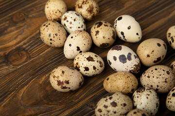 Quail eggs on a brown texture background.Organic food. Place for text. Fresh quail eggs.