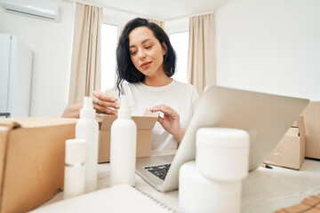 Online store employee packing wares for shipping