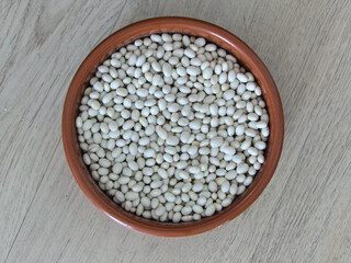 White coconut bean close-up in a clay dish - Texture background - Food