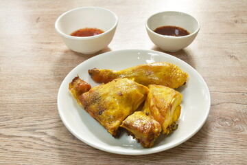 grilled chop chicken on plate dipping with spicy and sweet chili sauce