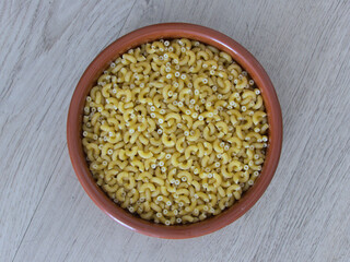 Shell pasta close-up in a clay dish - Texture background - Food