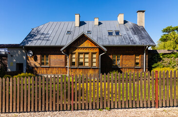 Reconstructed wooden country house aside St. Catherine Benedictine convent in Swieta Katarzyna village in Swietokrzyskie Mountains in Poland
